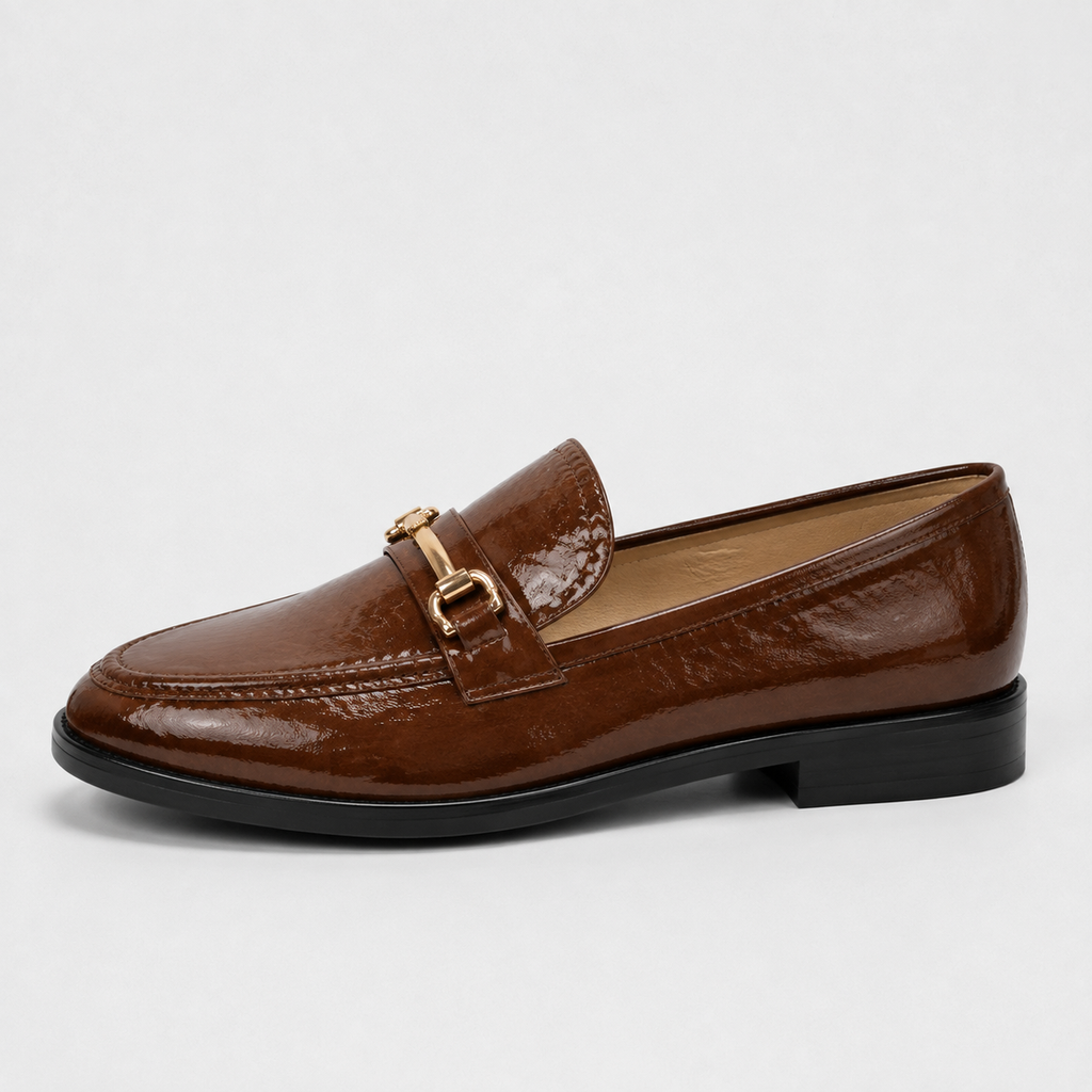 Side view of women's brown patent horsebit loafers