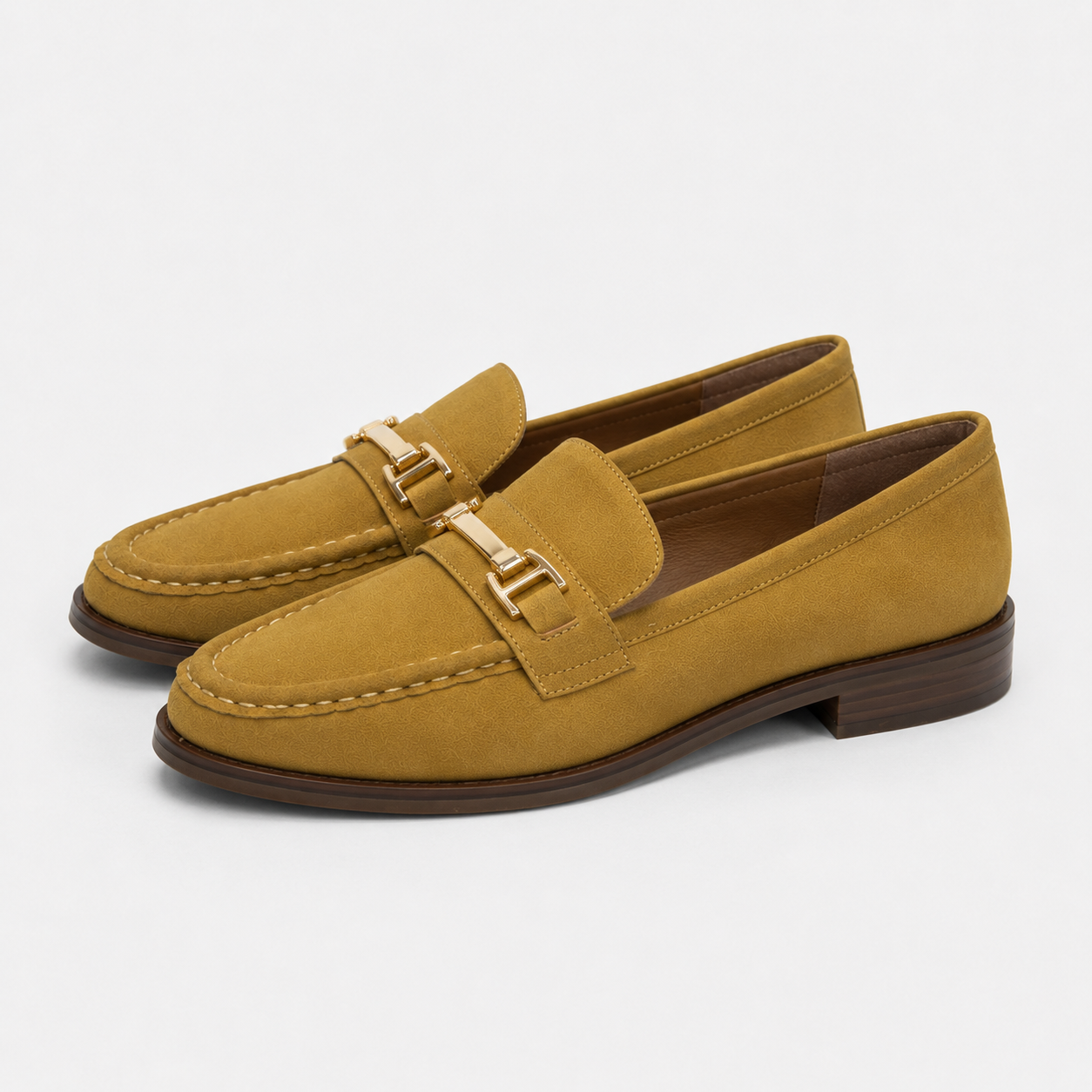 Side view of women's mustard horsebit loafers