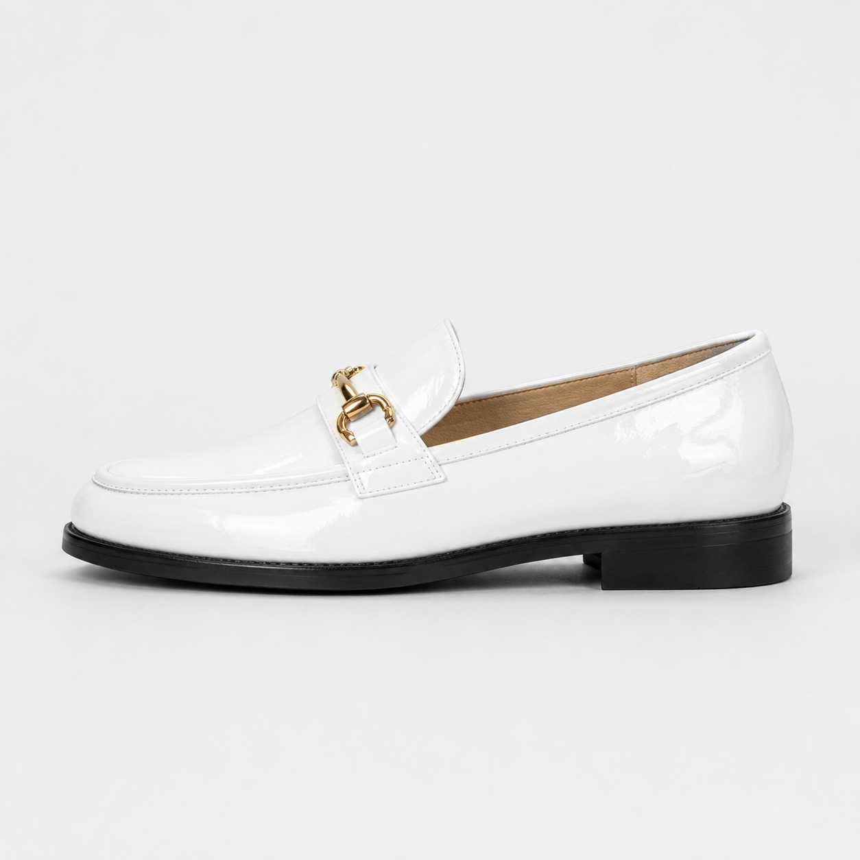 Side view of women's white patent horsebit loafers