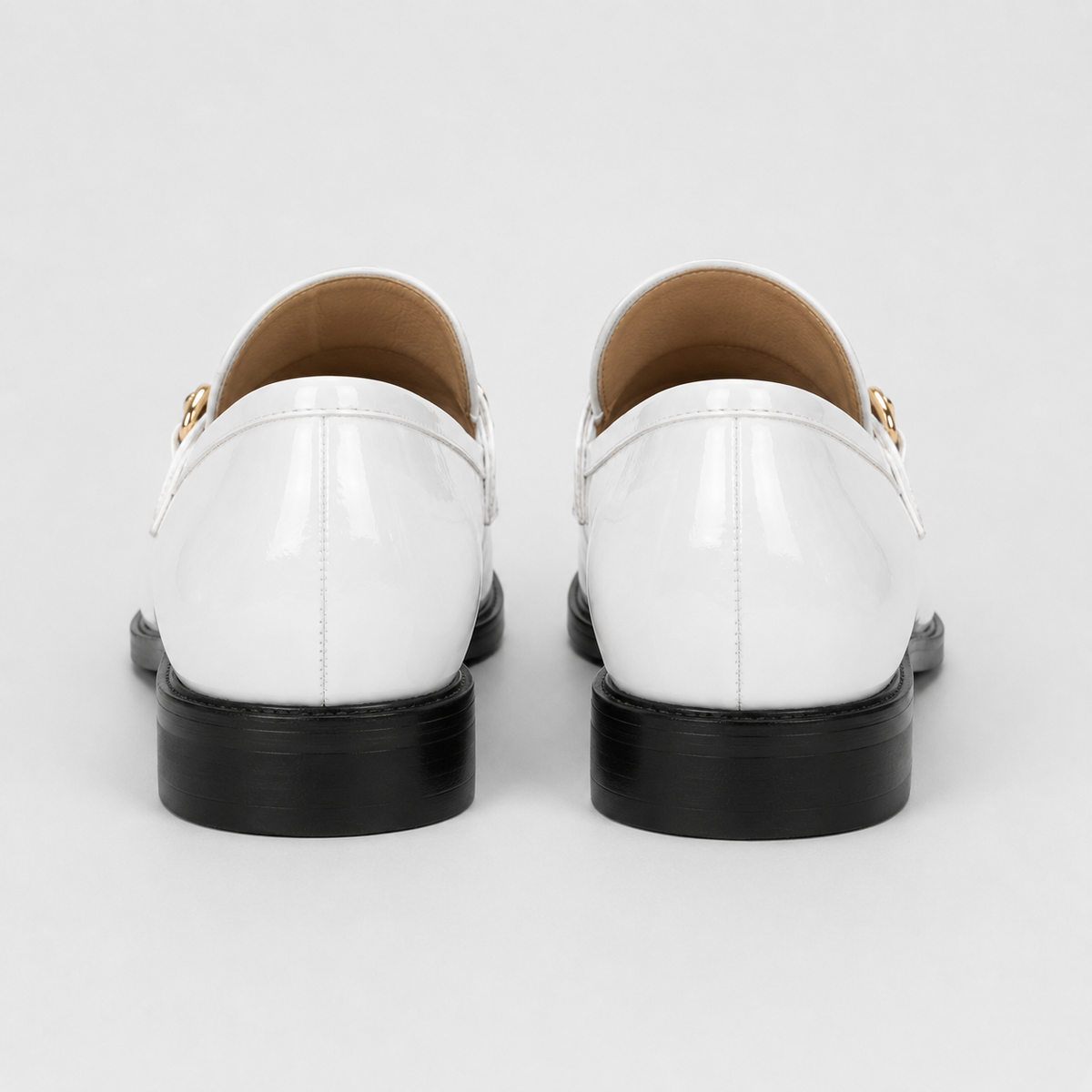 Back view of women's white patent loafers