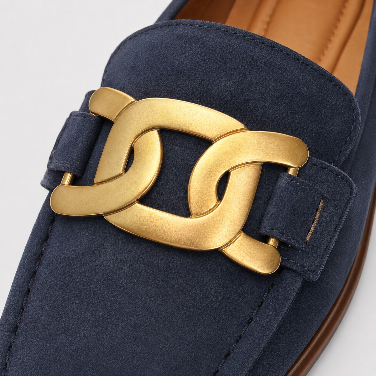 Gold-tone chain detail on women's navy loafers