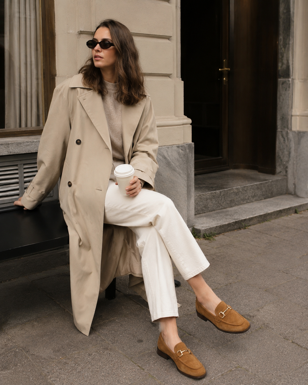 Women's brown horsebit loafers styled with jeans