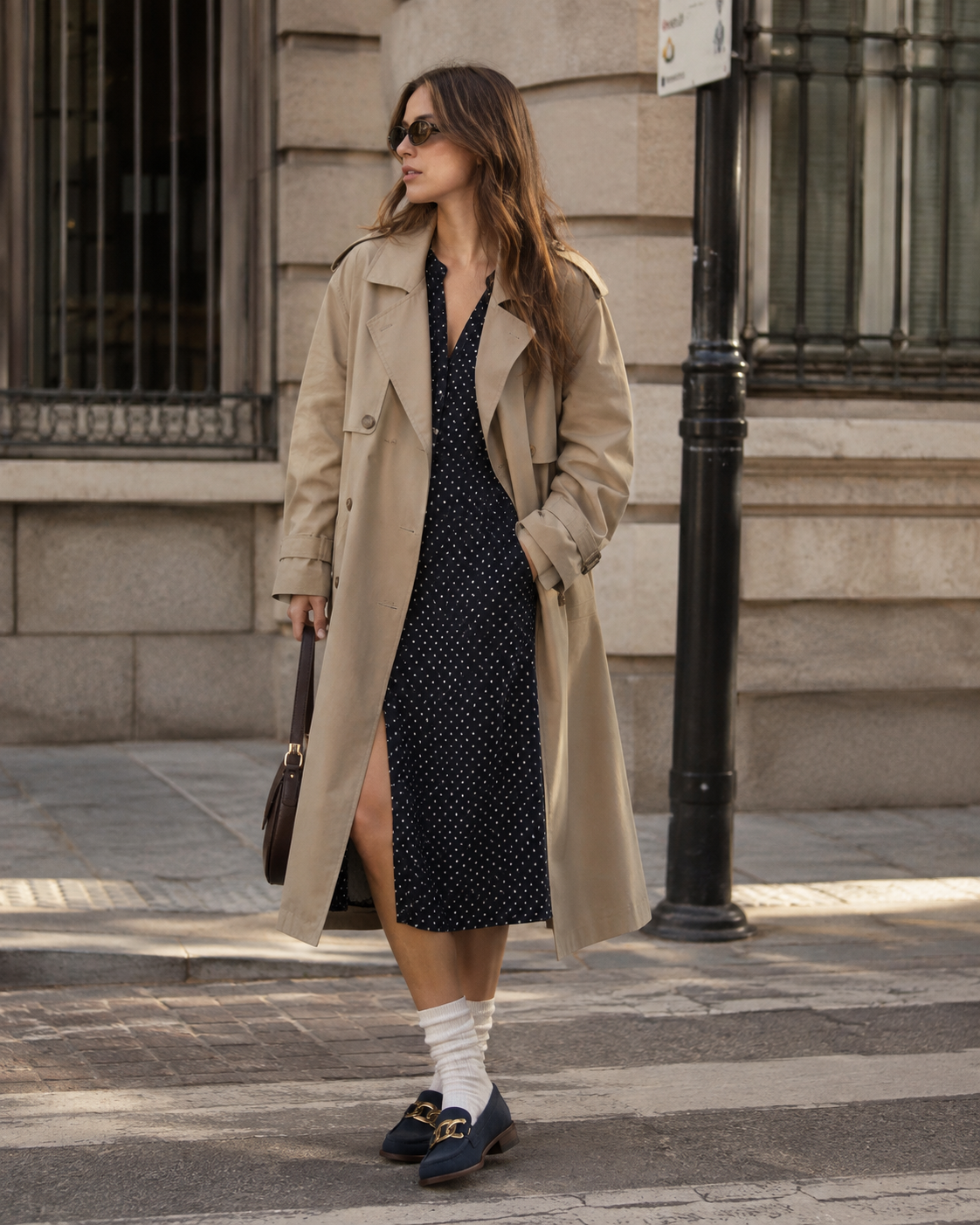 Women's navy chain loafers styled with a skirt