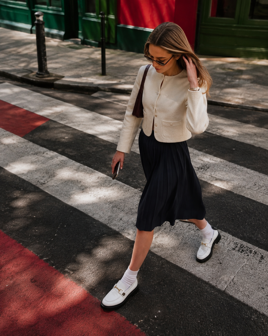 Women's white patent horsebit loafers styled with a skirt
