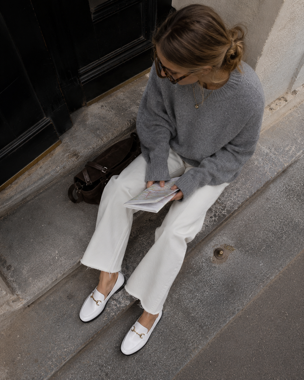 Women's white patent horsebit loafers styled with jeans