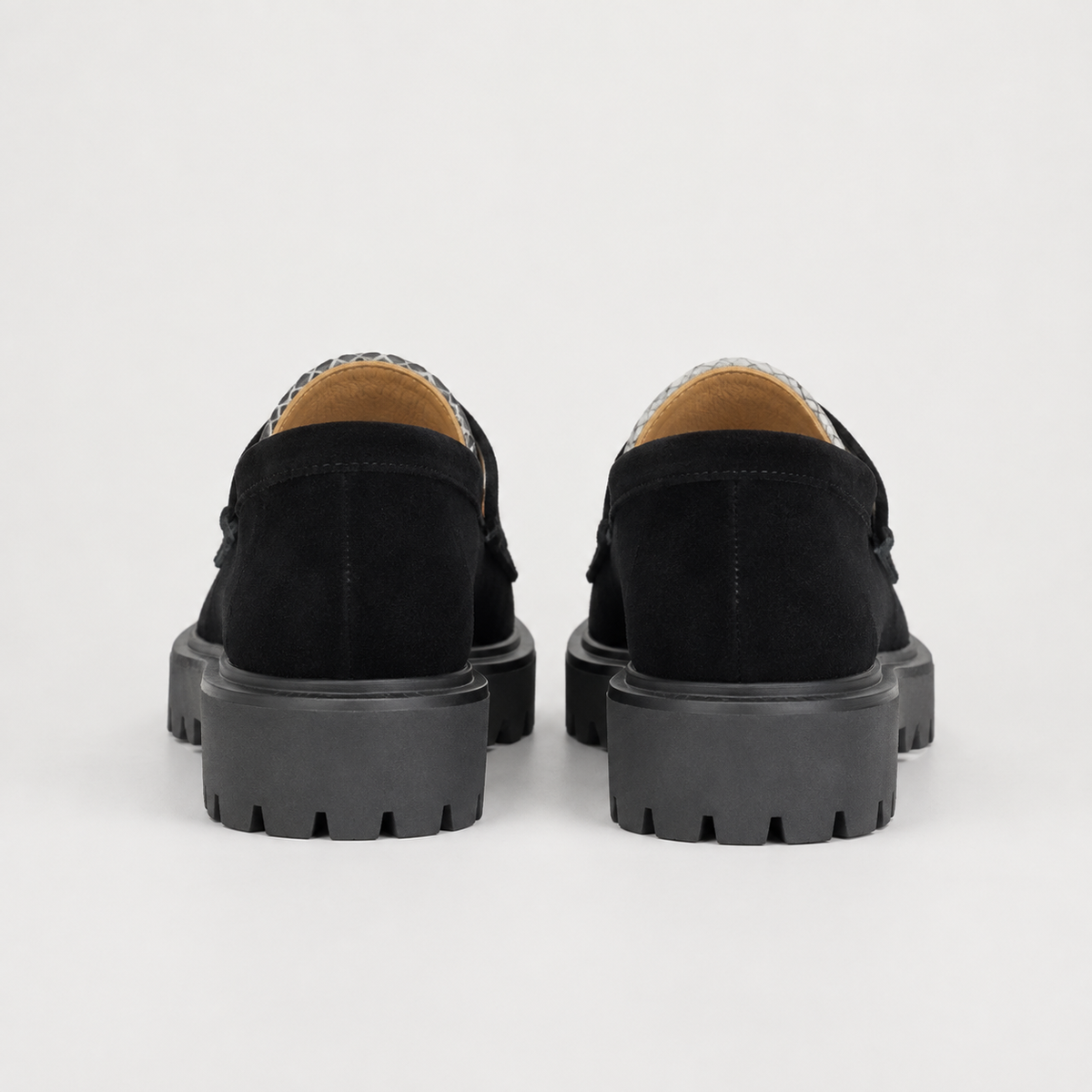 Black and white platform loafers with chunky lug sole, back view