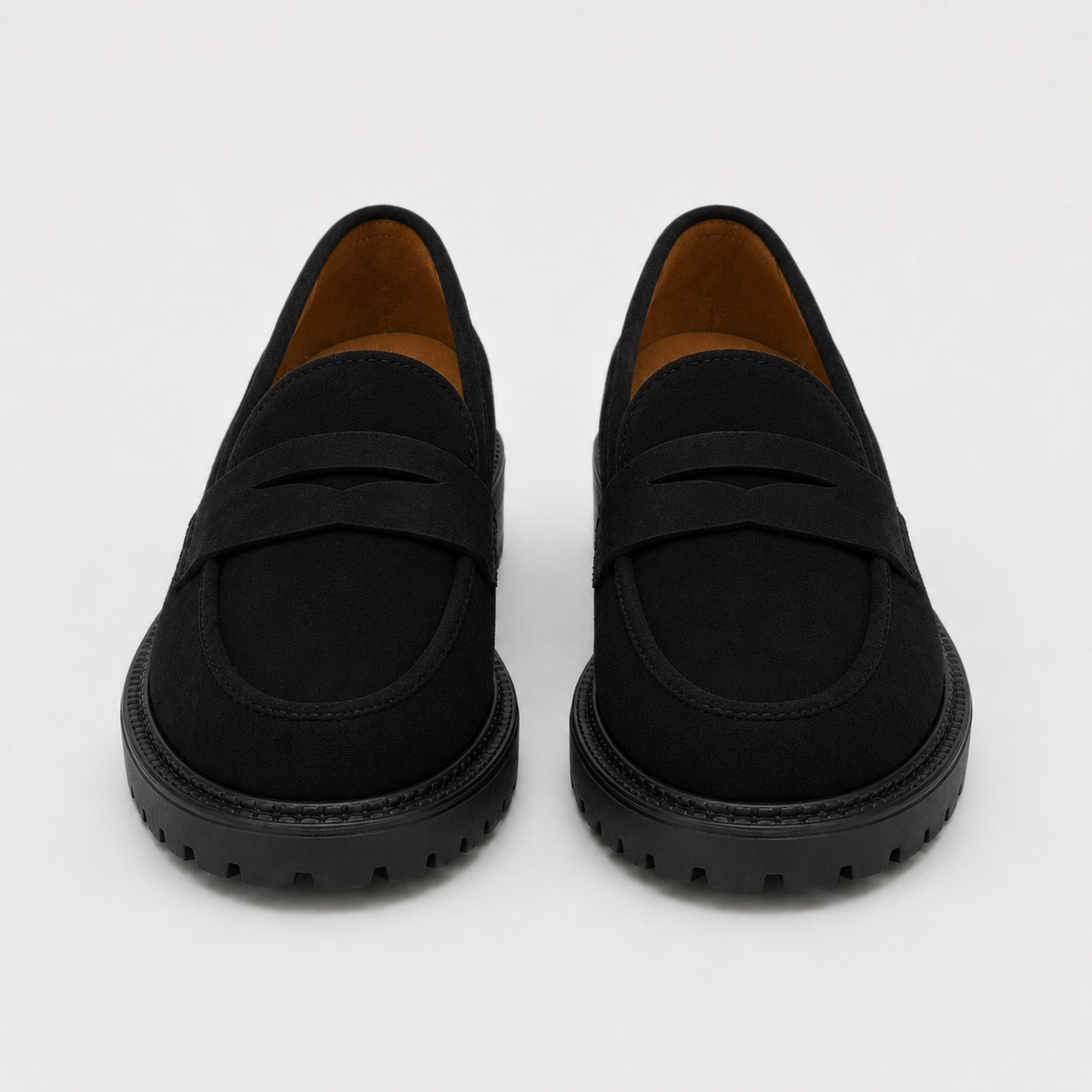 Women's black platform penny loafers with chunky lug sole, front view