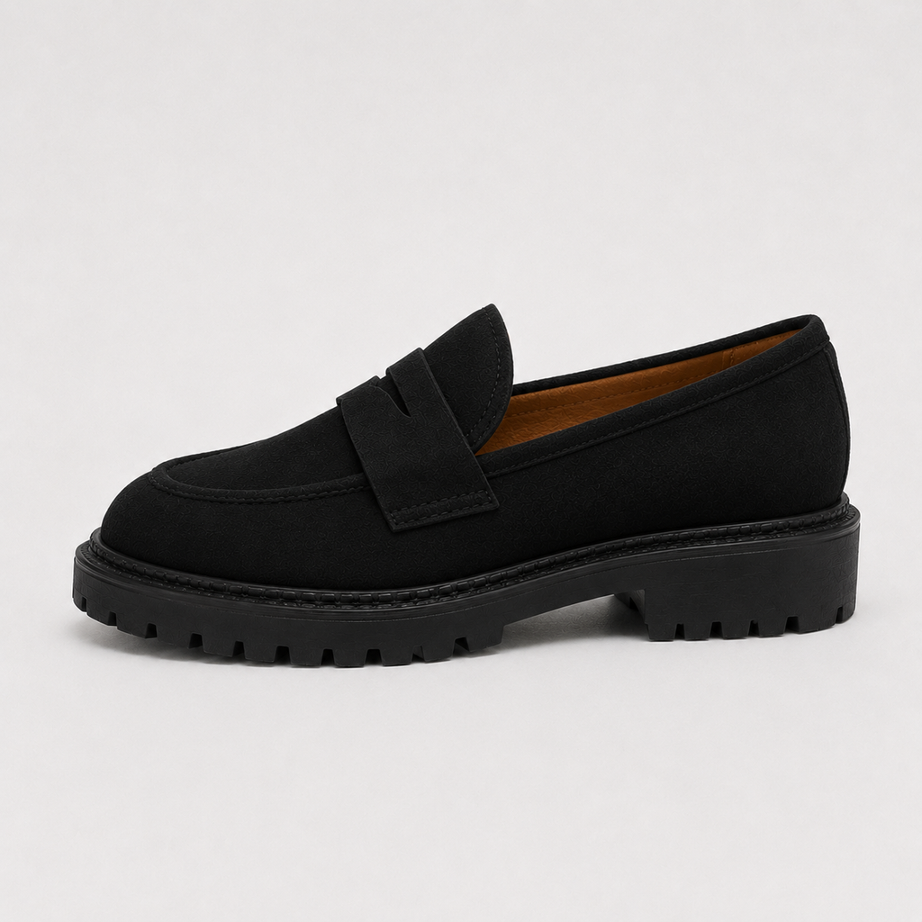Side view of women's black platform penny loafers with chunky lug sole