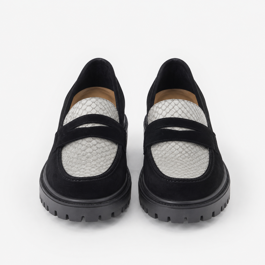 Women's black and white platform loafers with chunky lug sole, front view