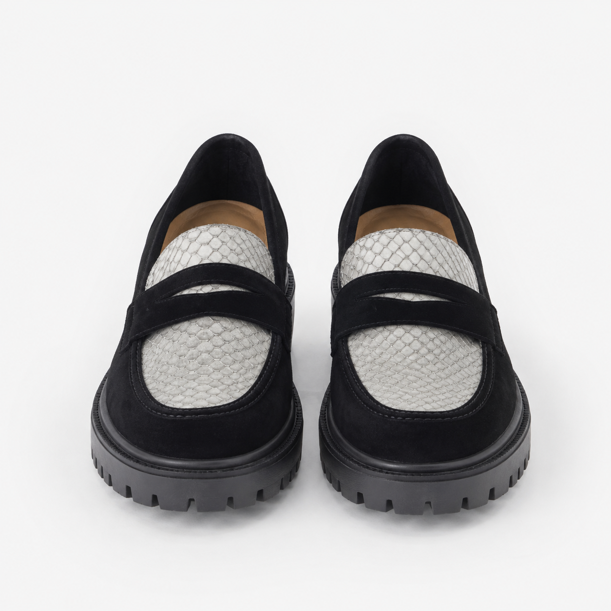 Women's black and white platform loafers with chunky lug sole, front view