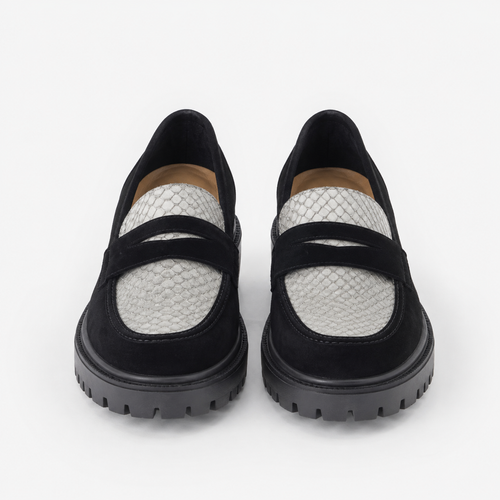 Women's black and white platform loafers with chunky lug sole, front view